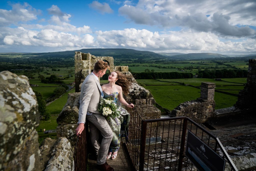 bride and groom on the roof of Bolton Castle