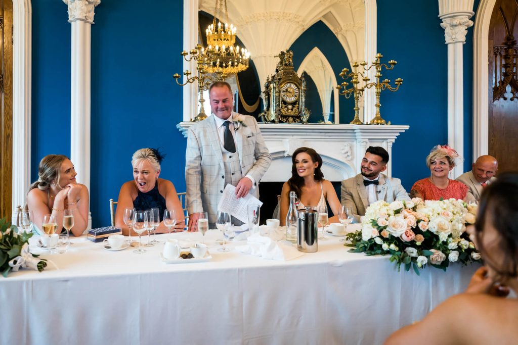 wedding guests smiling at top table
