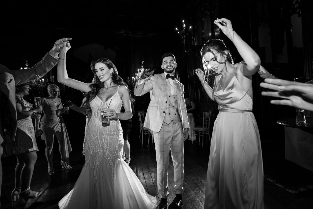 bride and groom dancing with wedding guests