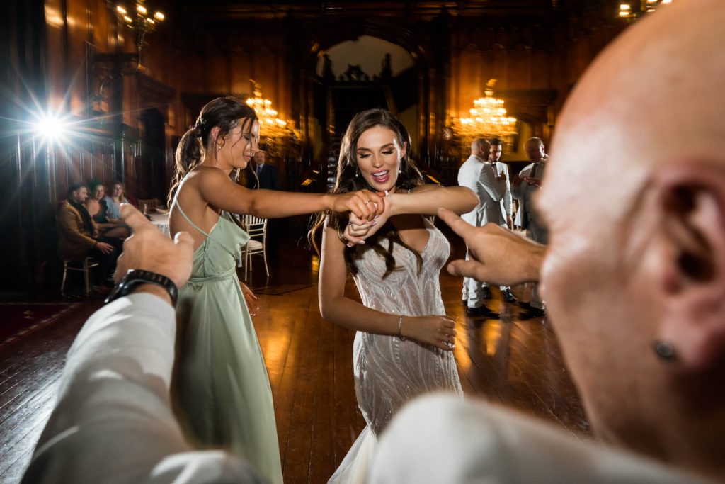 bride dancing with her bridesmaid on the dance floor