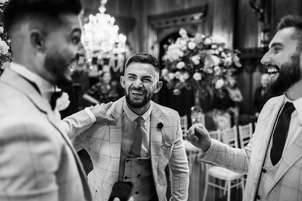 groom laughing with his groomsmen