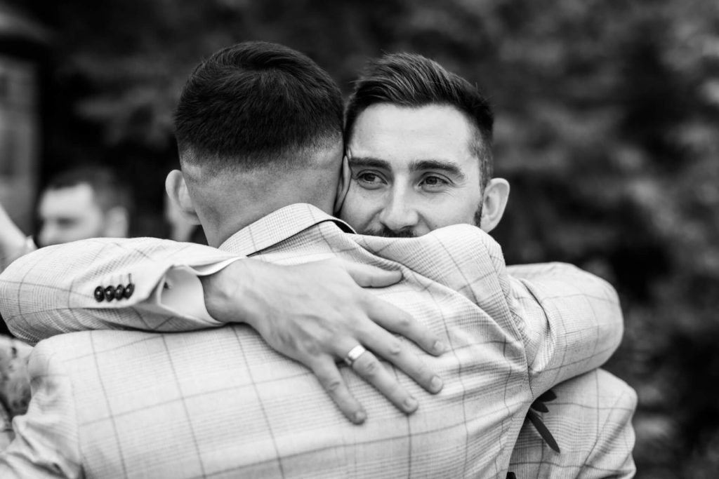 groomsman hugging the groom