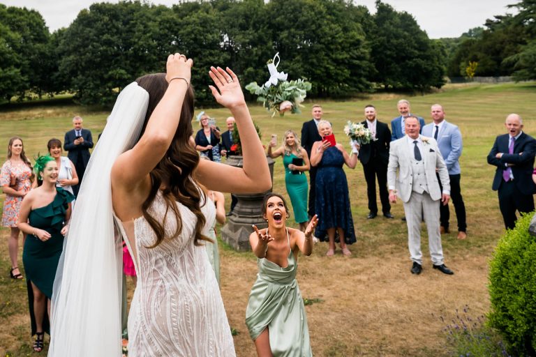 bridesmaid catching the wedding bouguet