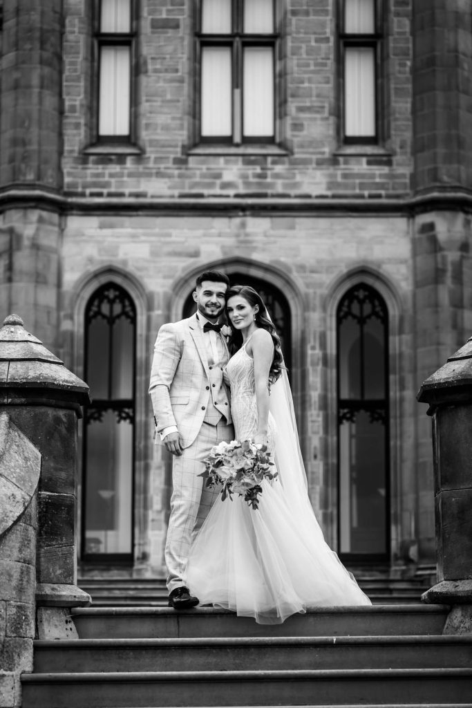 bride and groom together on the steps at Allerton Castle