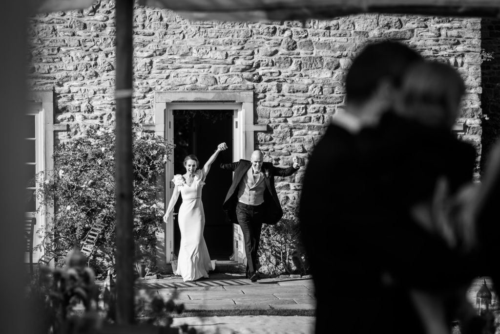 wedding couple leave Eden house to enter the marquee for their wedding breakfast
