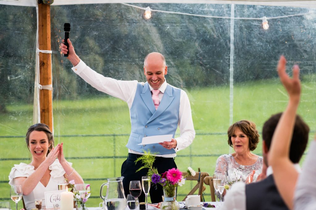 guests applauding the groom during his speech