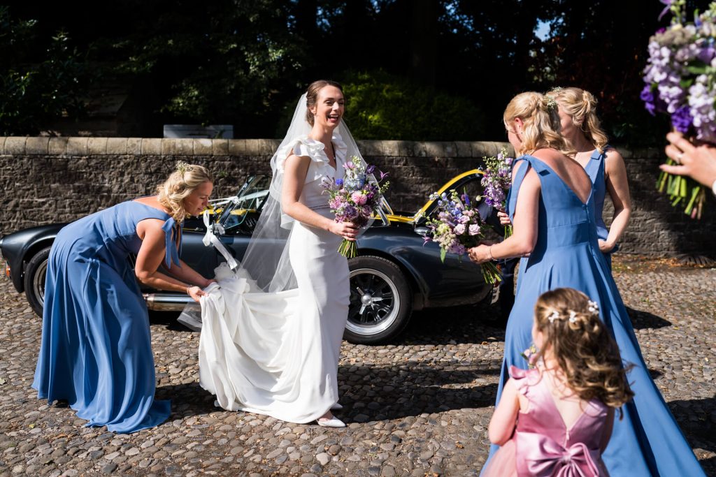 bridesmaids greeting the bride as she arrives at the church