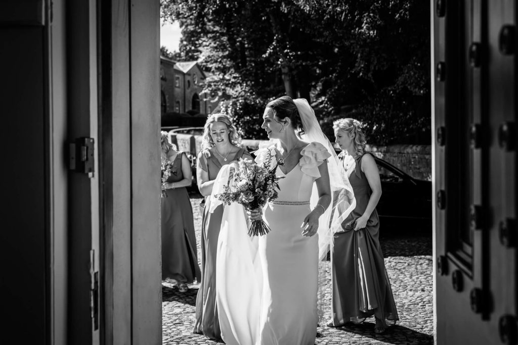 bride walking in through the church doors