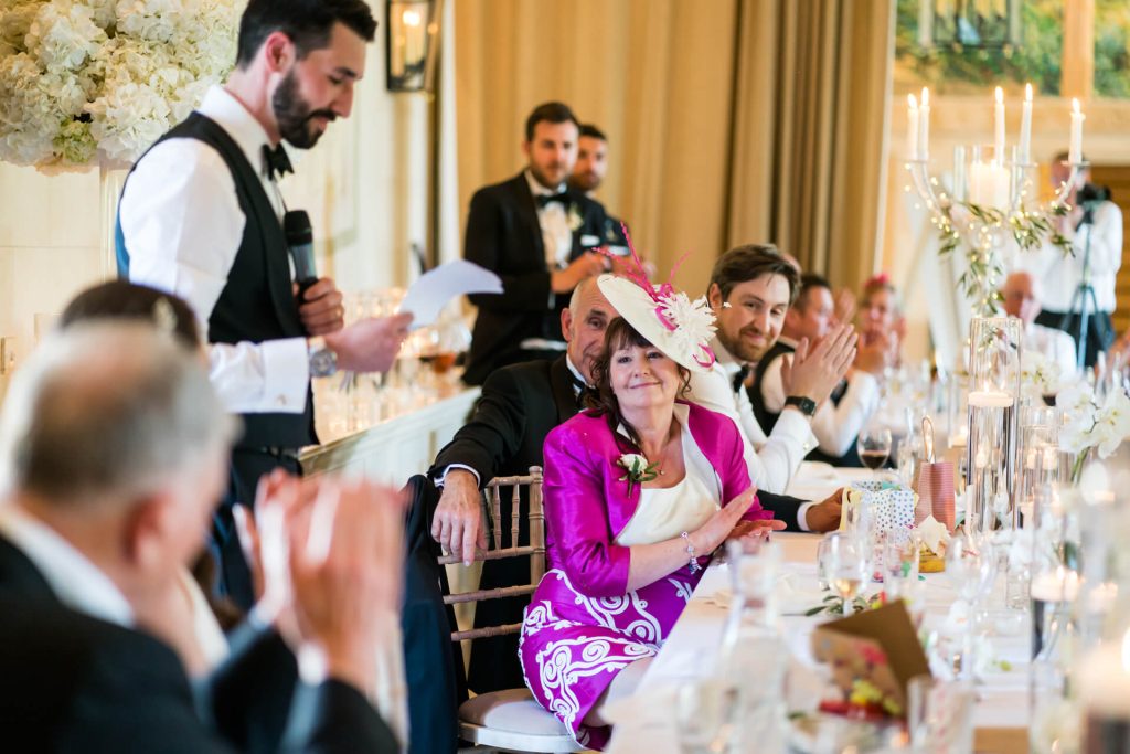 wedding guests clapping during the wedding speeches