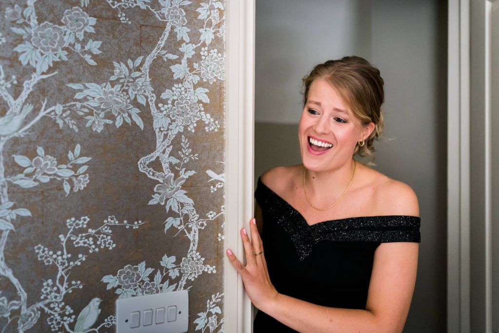 bridesmaid looking into the room and smiling