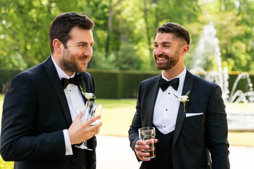 two groomsmen chatting together