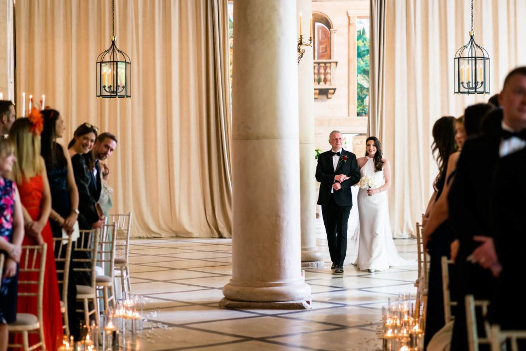 bride and her father walking the ceremony aisle at the orangery at Settrington