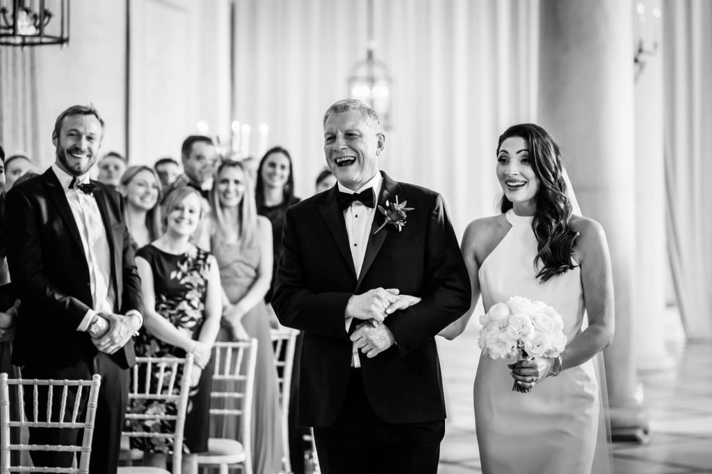 bride and her father walking down the aisle at the orangery at Settrington
