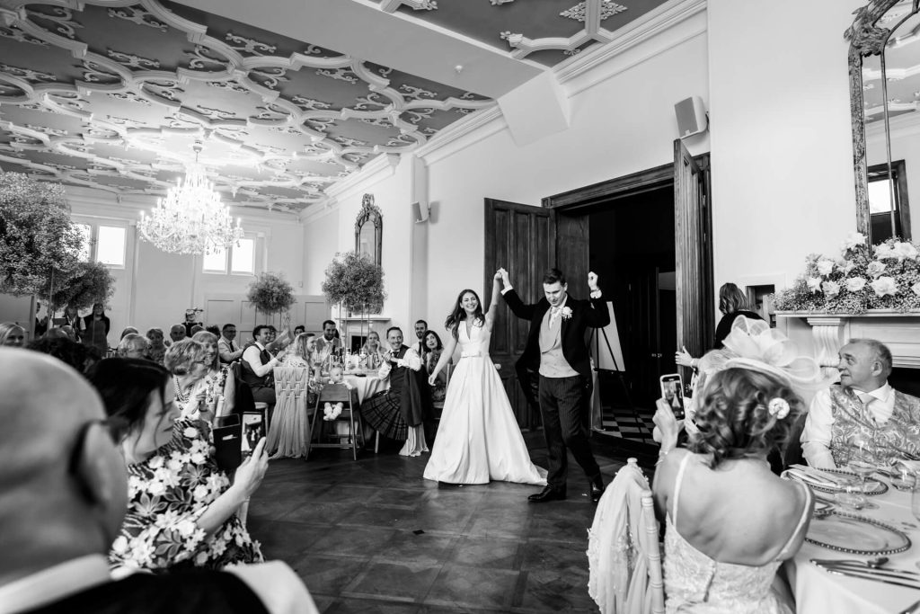 bride and groom entering the wedding breakfast room to much applause at Thicket Priory