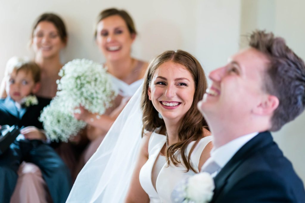 bride looking at the groom as he laughs