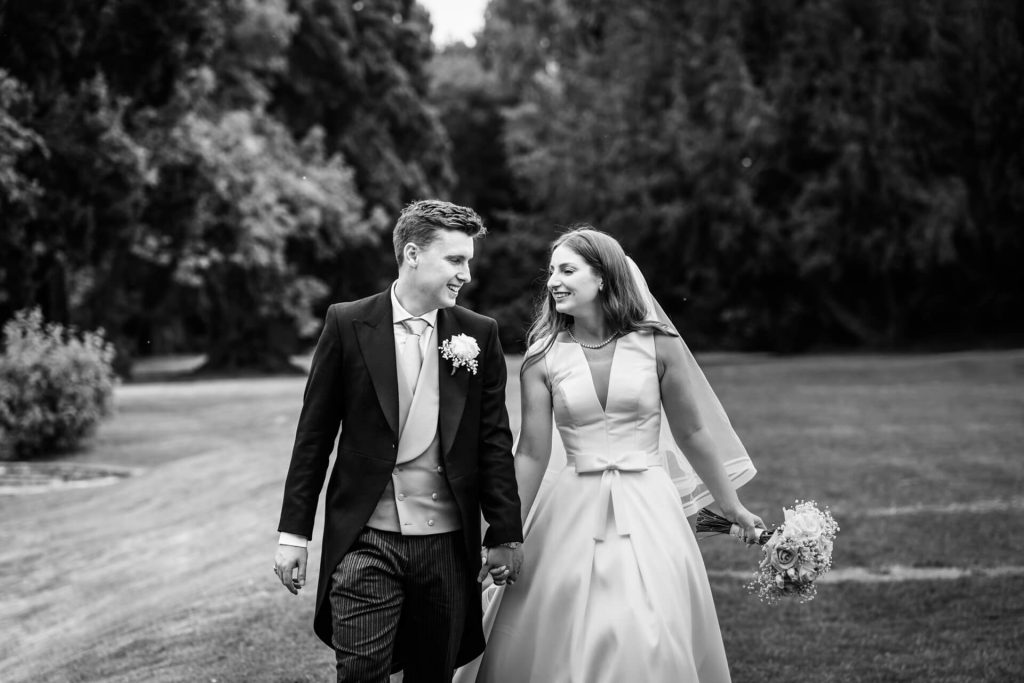 bride and groom walking in the gardens at Thicket Priory