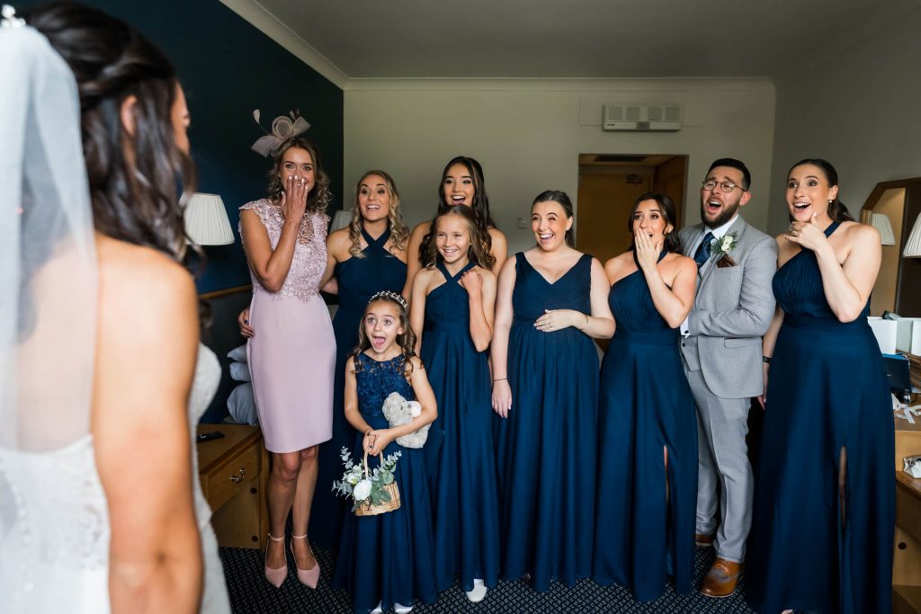 bridal party's reaction to seeing the bride in her dress