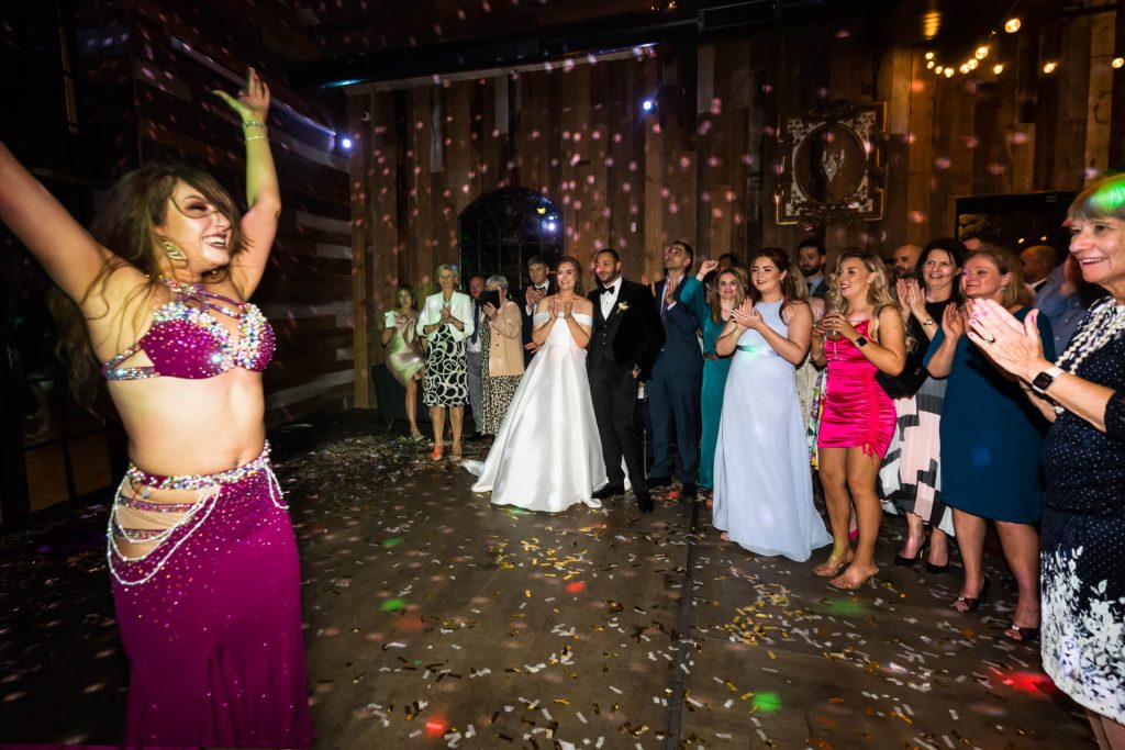 audience clapping whilst belly dancer performs