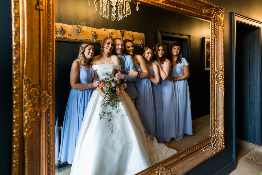 bride with bridal parry all looking in a big mirror at Wharfedale Grange