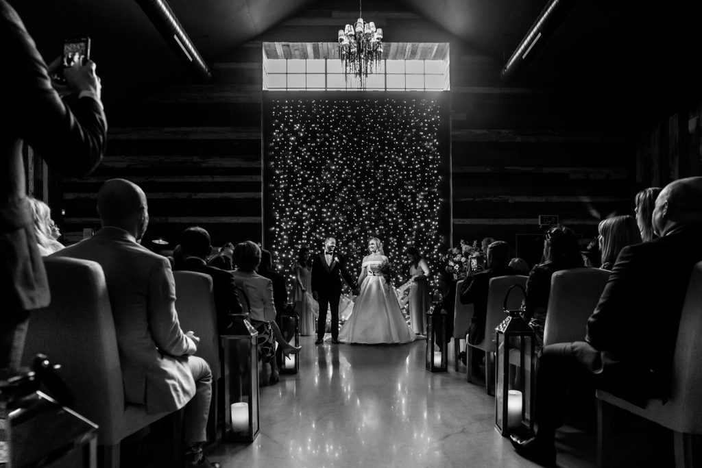 bride and groom at the top of the aisle waiting to walk out