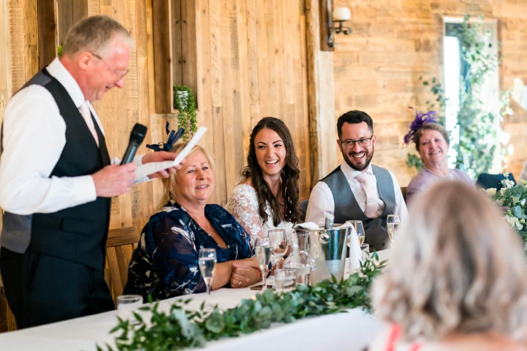 top table laughing during the father of the bride's speech