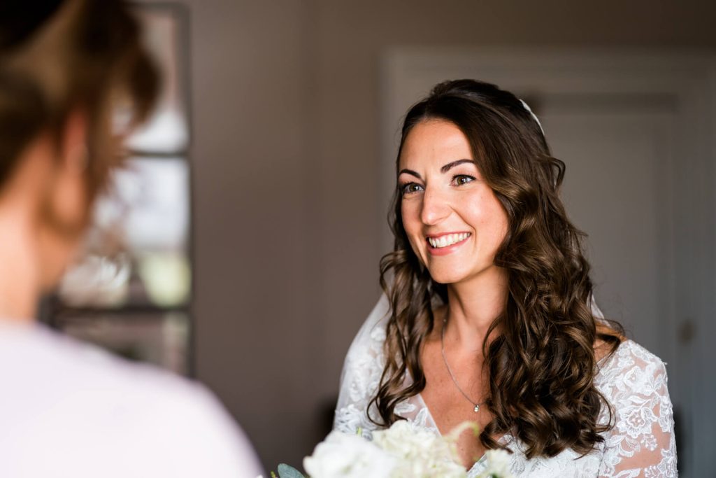 bride looking at a bridesmaid and smiling at The Principal York