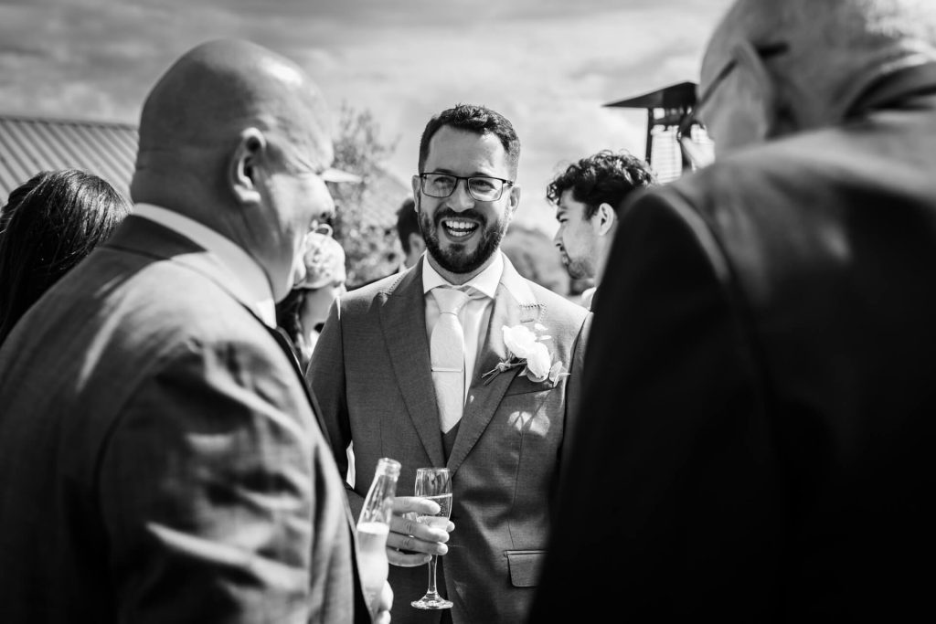 groom chatting with wedding guests
