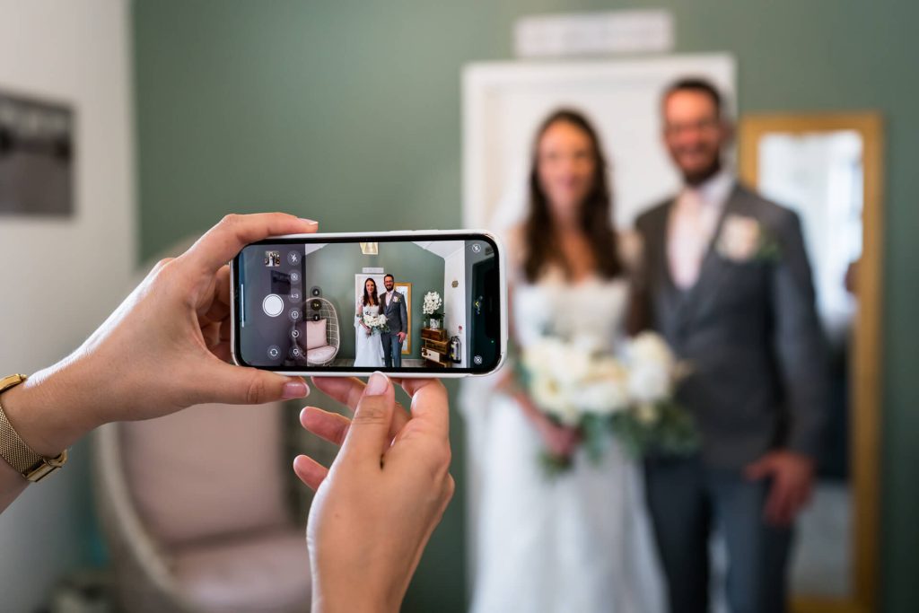 image of the couple on a wedding guest's phone