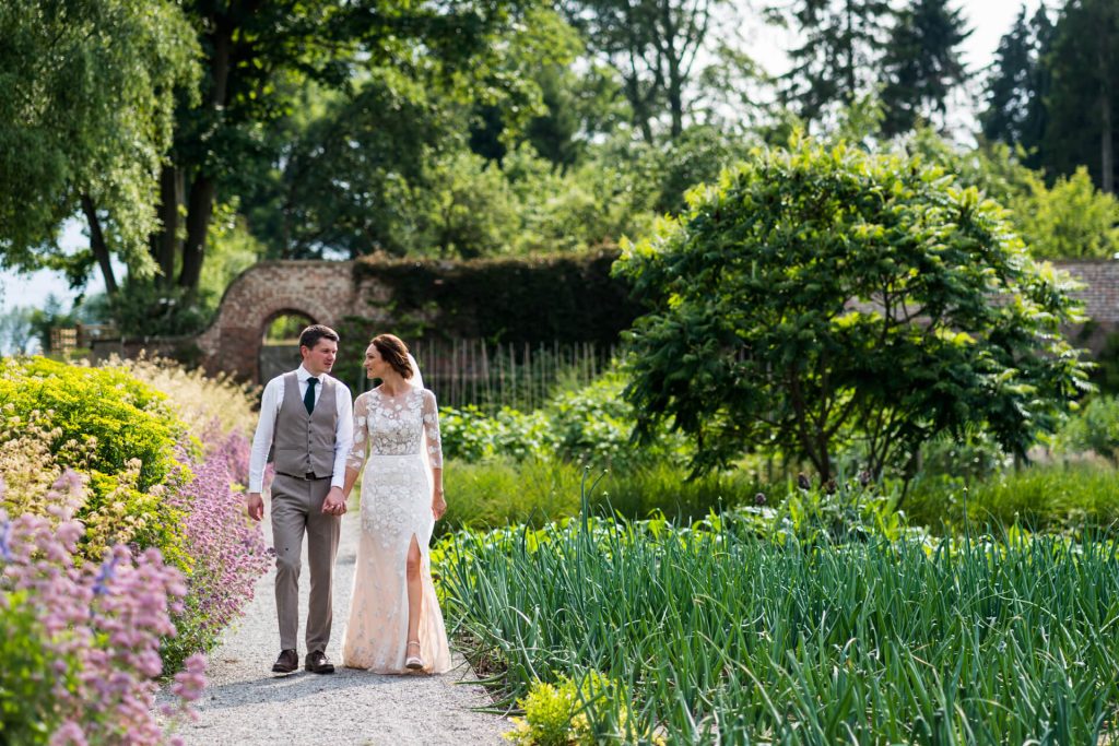 bride and groom walking in the gardens on the Middleton Lodge estate