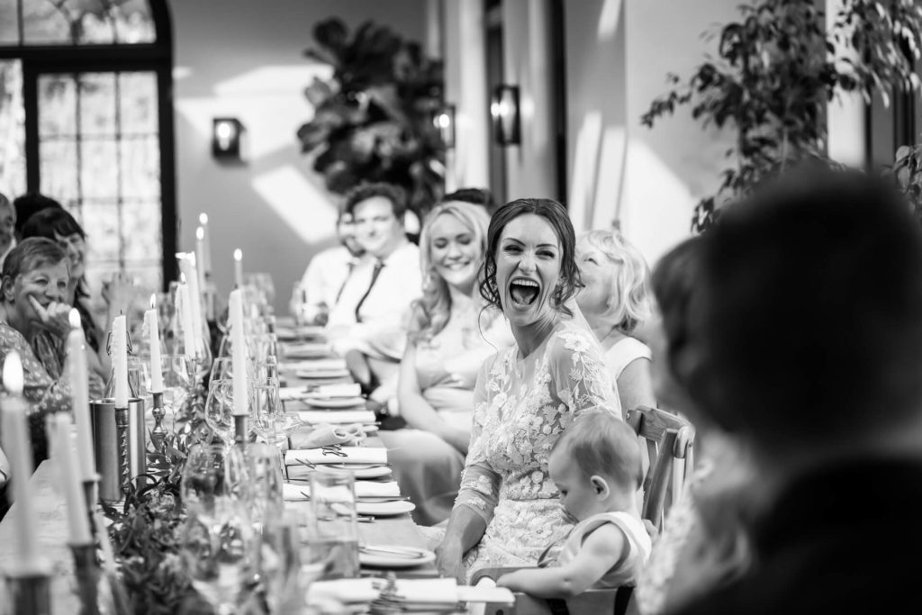 bride laughing during the speeches