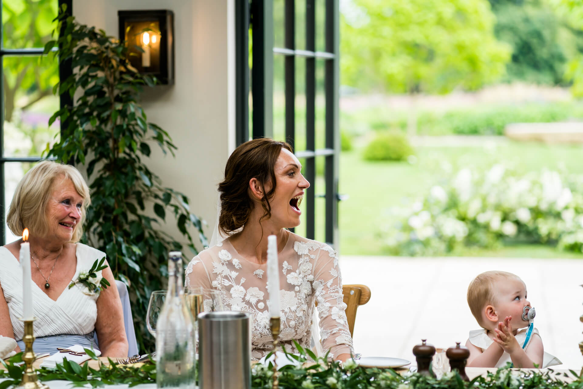 bride and her mother and her baby girl all reacting to the speeches