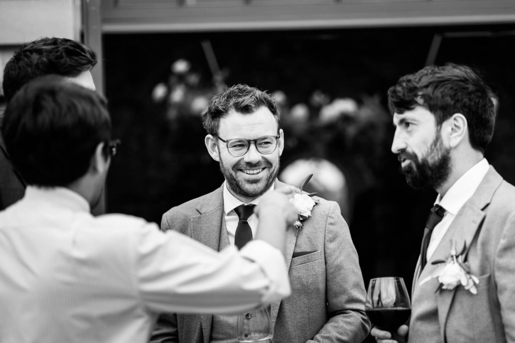 groomsmen chatting with guests