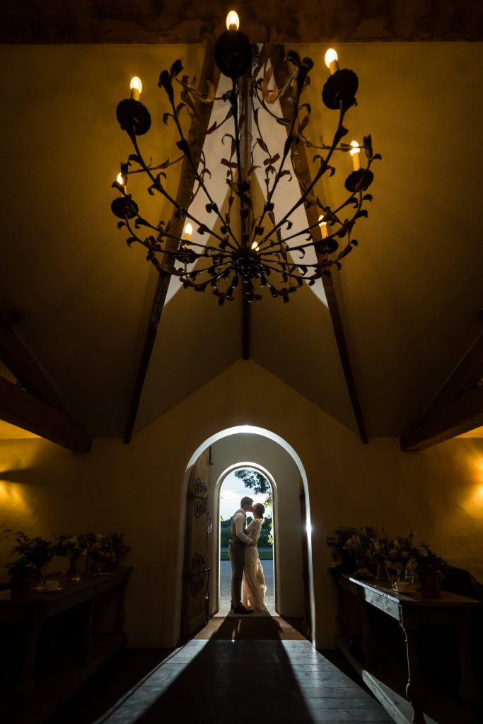 bride and groom kissing under an archway at the Fig House on the Middleton Lodge estate