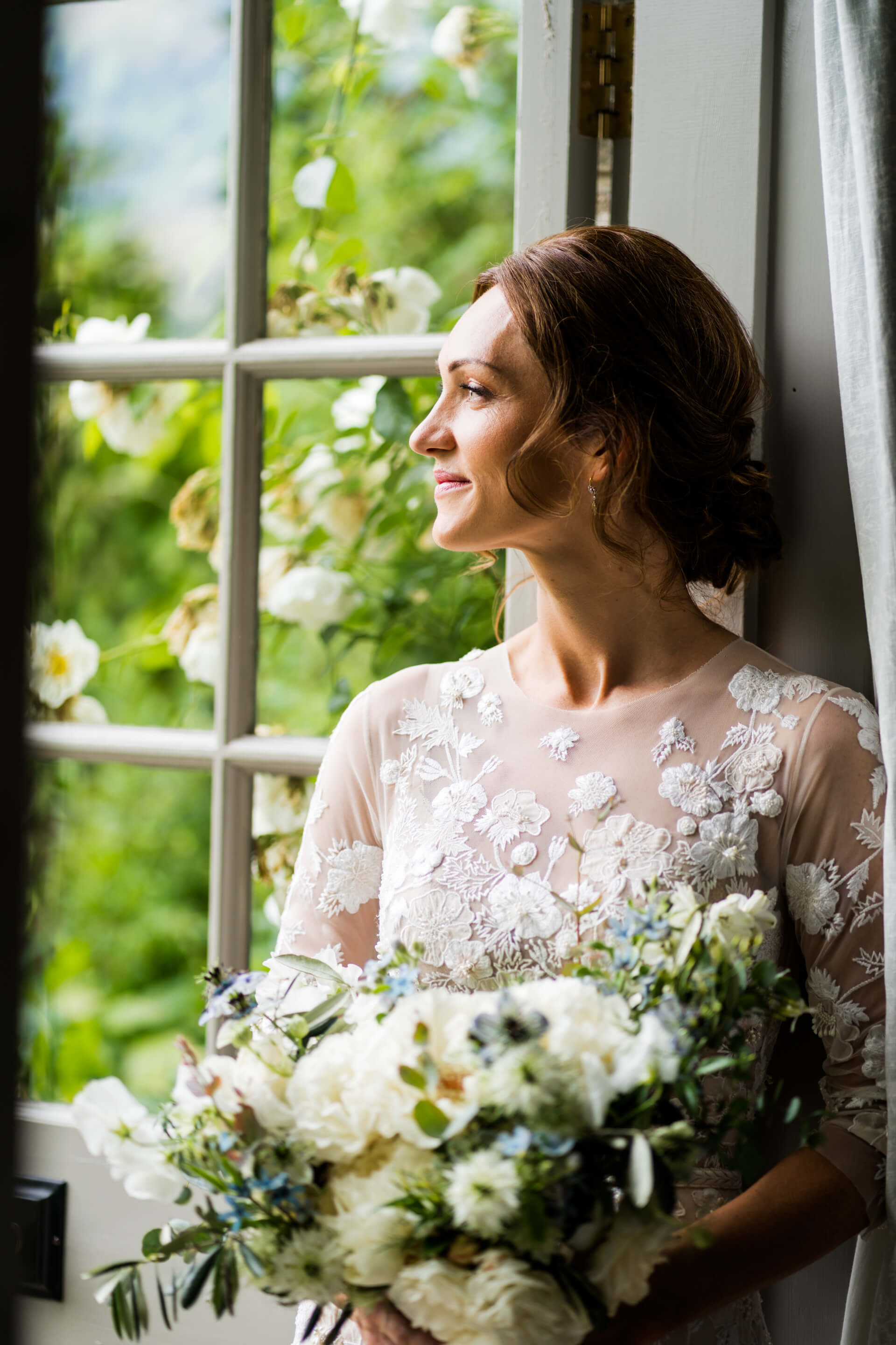 bride looking out of a window at Middleton Lodge