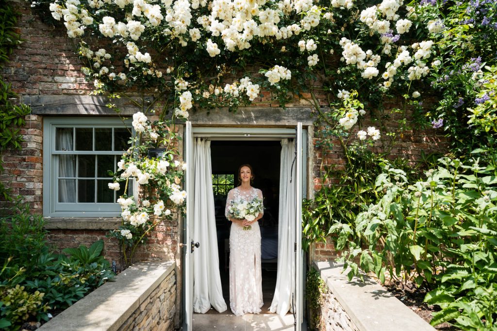 bride in the doorway to the bridal suite at the Fig House Middleton Lodge