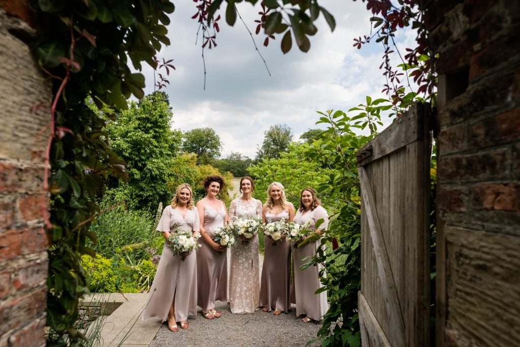 bridesmaids standing together in the gardens at Middleton Lodge