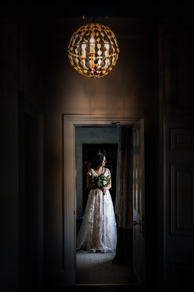 bride looking out of the bridal suite window at Saltmarshe Hall