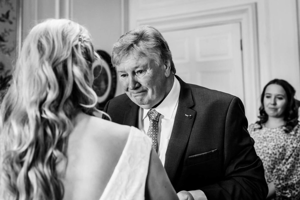 Brides father looking at her lovingly