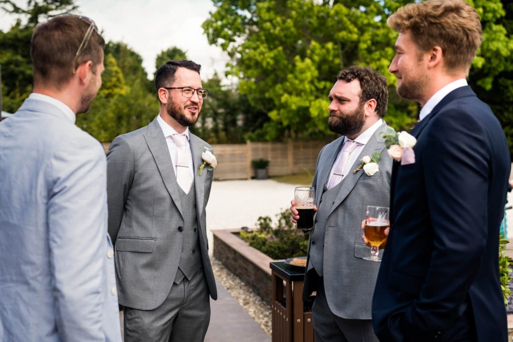 groom chatting with some wedding guests