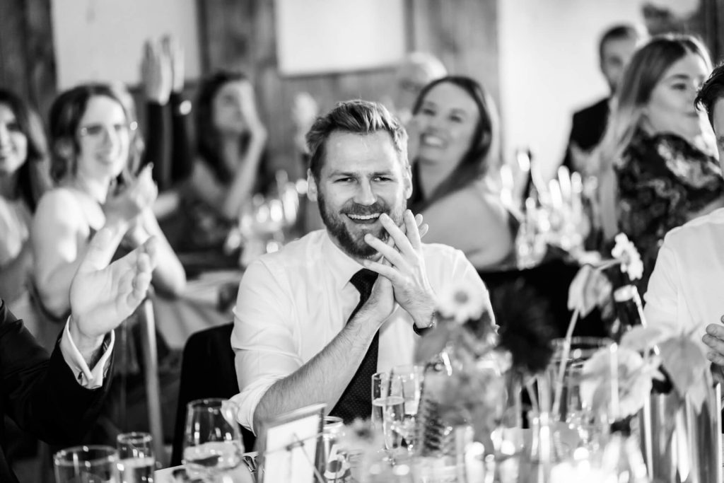 a wedding guest clapping