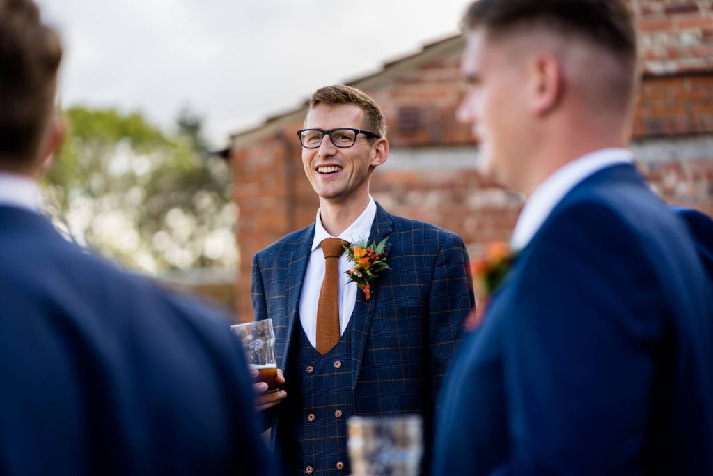 Groom laughing with some groomsmen