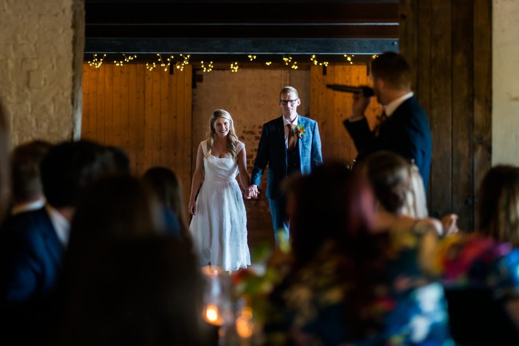 bride and groom wait whilst being announced in to the wedding breakfast room at Woolas Barn