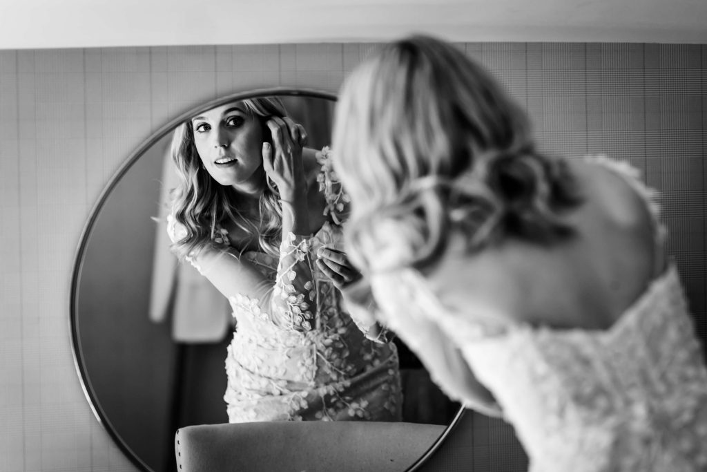 bride looking at her reflection, black and white photo.
