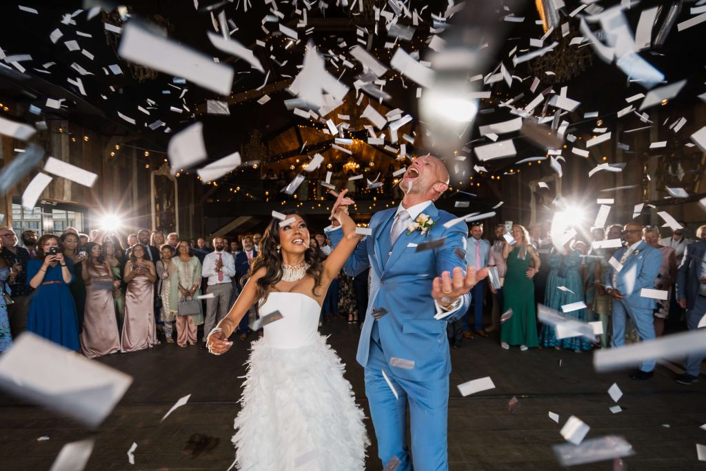Joyful couple celebrating with confetti on the dancefloor at Wharfedale Grange