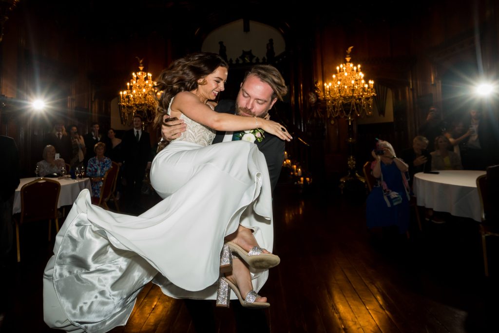 Bride and groom dancing in elegant hall at Allerton Castle