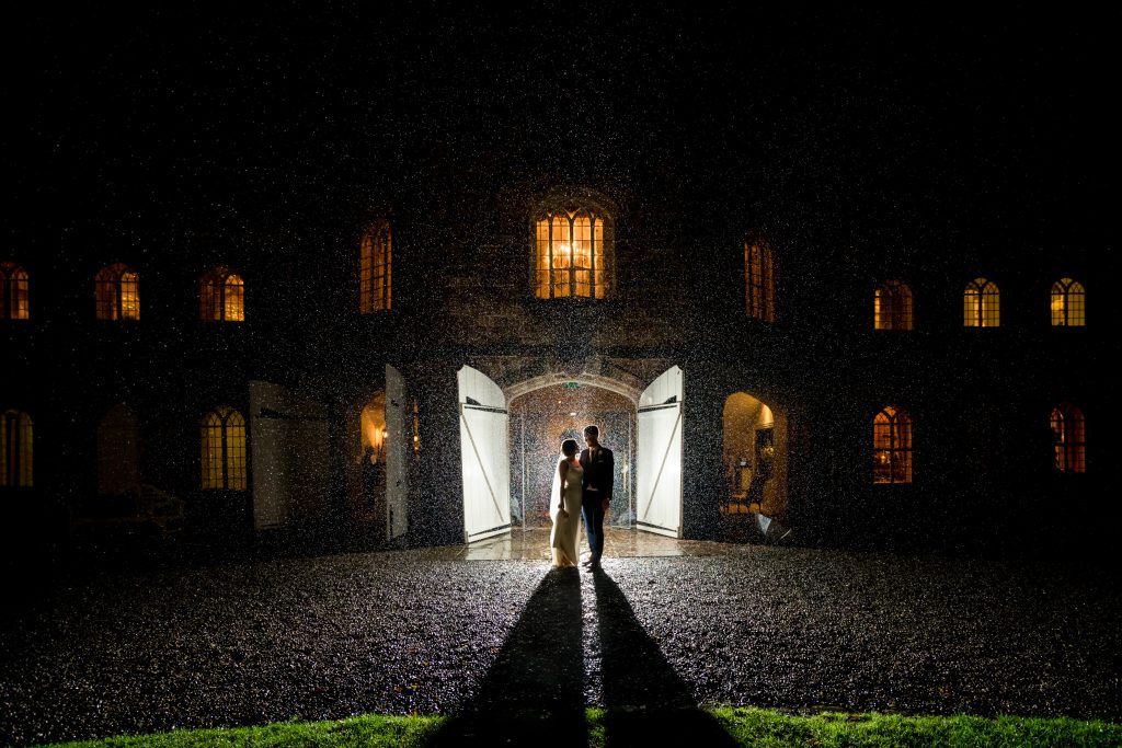 Couple silhouette, illuminated doorway, rainy night at Ripley Castle
