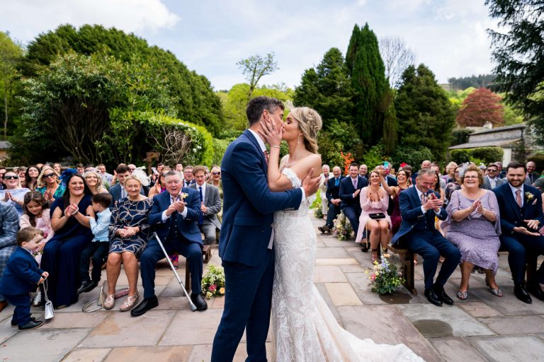Couple kissing at outdoor wedding ceremony at the Towhead Estate