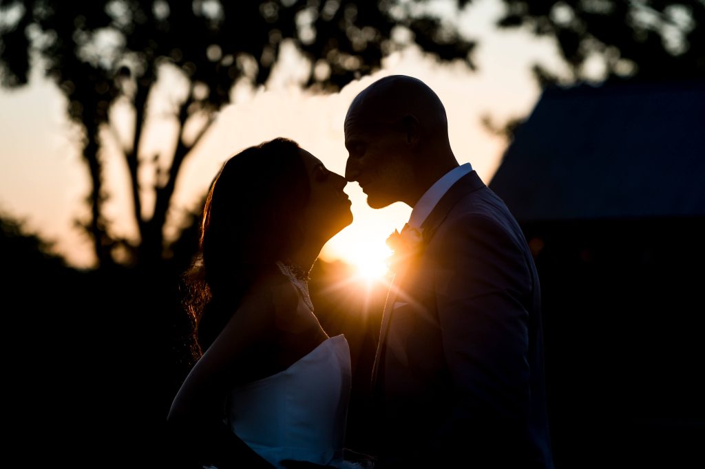 Couple silhouette sunset wedding kiss at Wharfedale Grange