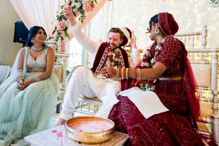 Indian wedding ceremony, joyful couple performing rituals.
