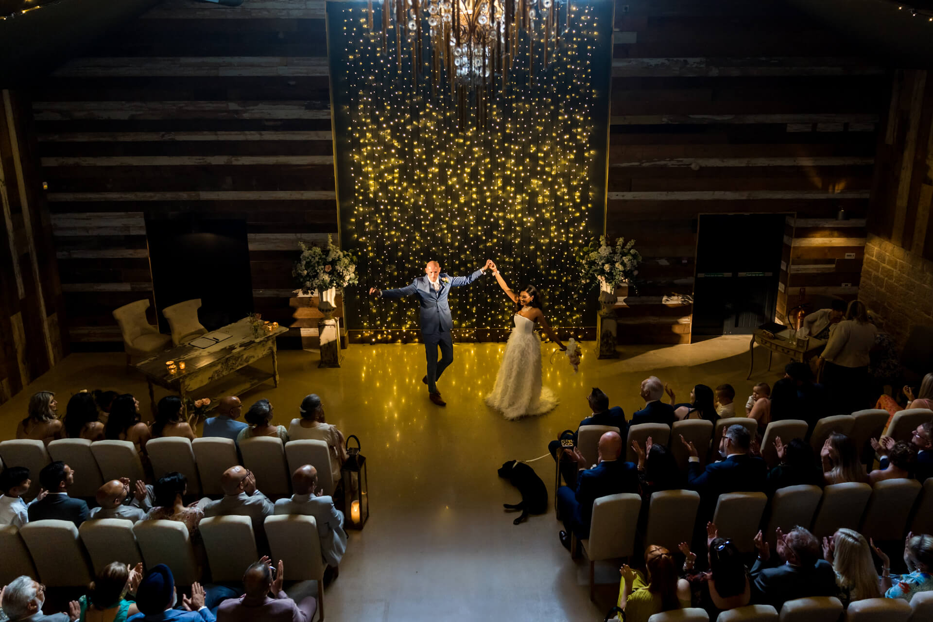 Bride and groom first dance with fairy lights backdrop.